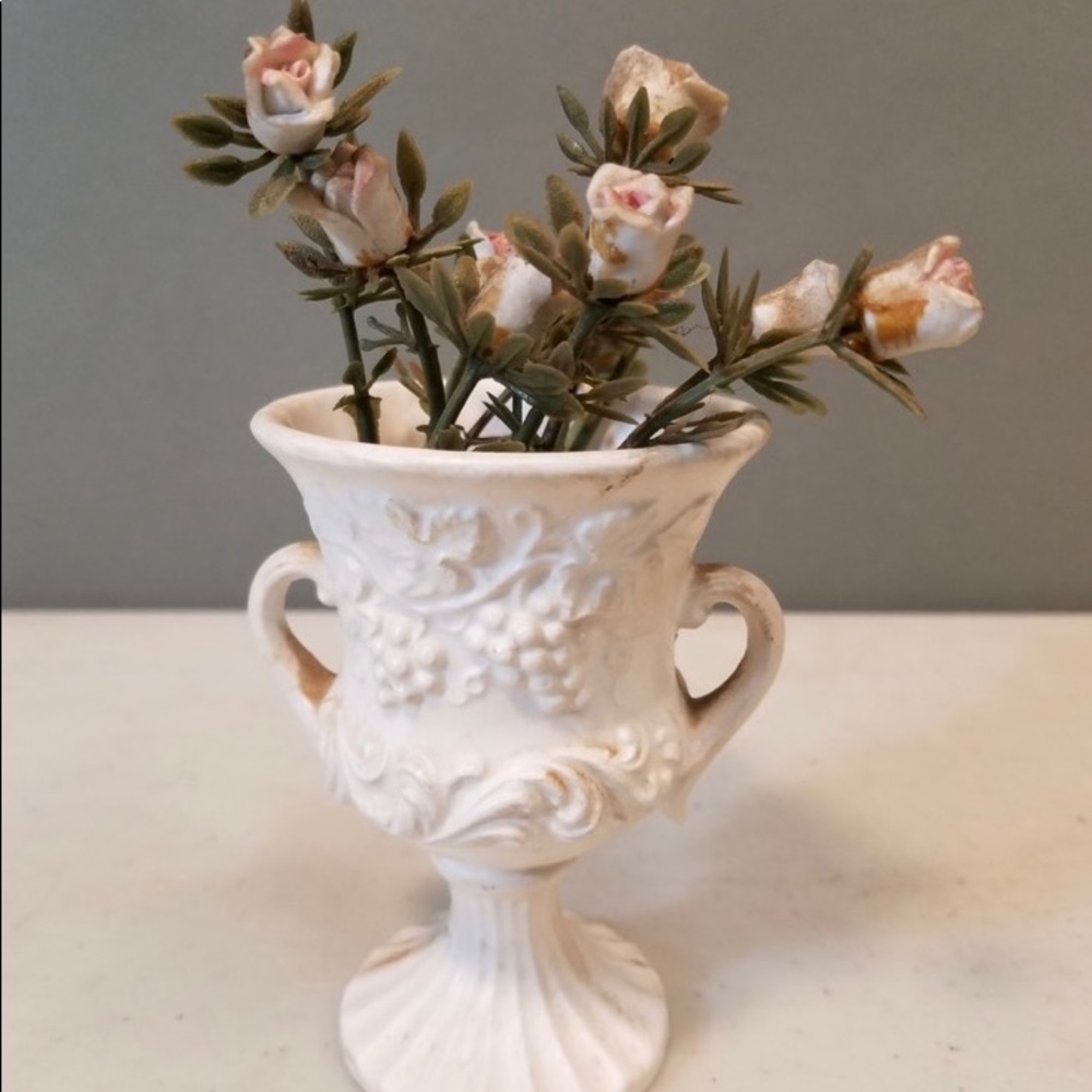 Vintage bouquet of ceramic flowers in a classical ceramic planter.